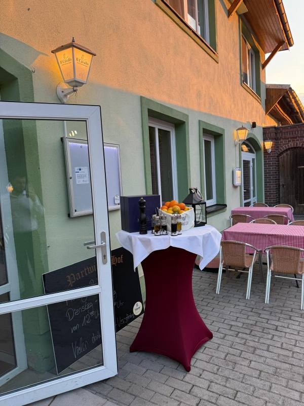 Eingang mit Laterne und Tischen im Hof