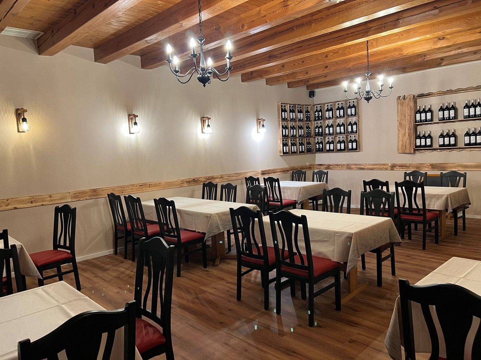 Function room with wooden beam ceiling and laid tables